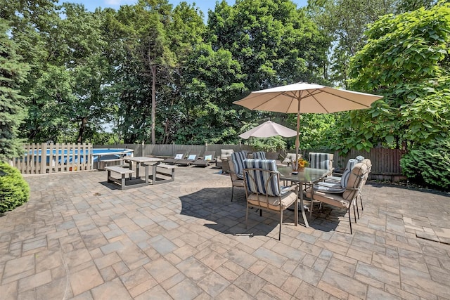 11 Beverly Ln, Peekskill, NY 10566 - fenced backyard with outdoor lounge area, a patio, outdoor dining area, and view of wooded area