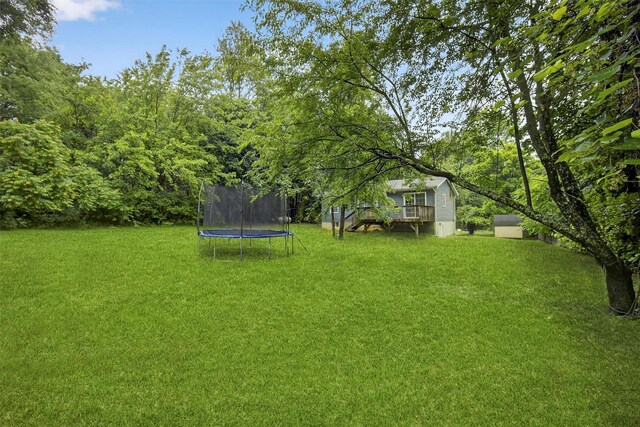7 Jorge Ln, Wallkill, NY 12589 - view of grassy yard with a trampoline and a deck