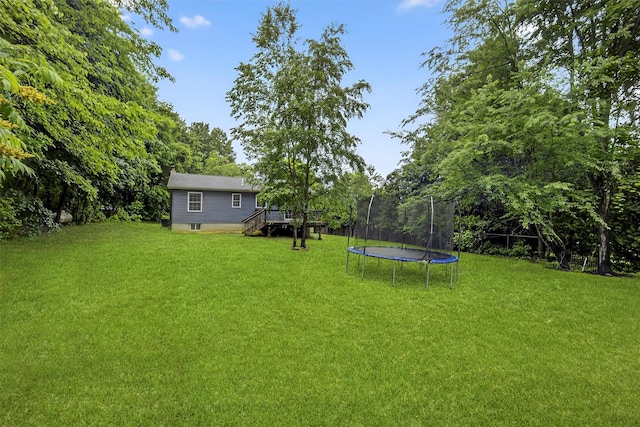 7 Jorge Ln, Wallkill, NY 12589 - view of green lawn with a trampoline, a deck, and stairs