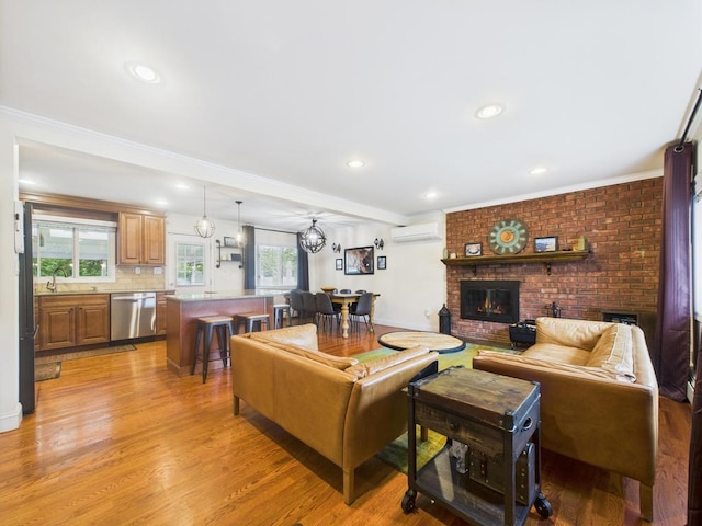 260 9th St, Bethpage, NY 11714 - living area with an AC wall unit, a fireplace, light wood finished floors, recessed lighting, and crown molding