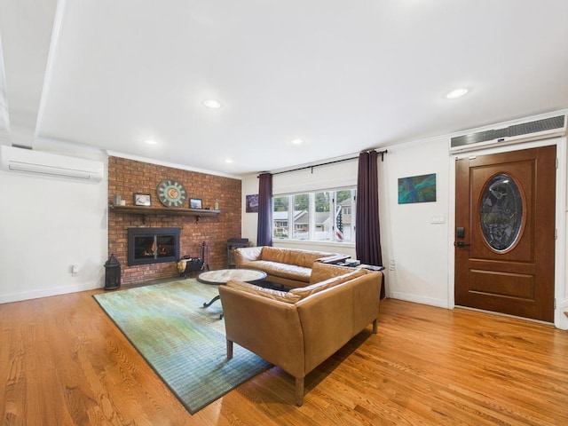 260 9th St, Bethpage, NY 11714 - living room featuring a wall unit AC, wood finished floors, ornamental molding, a brick fireplace, and recessed lighting