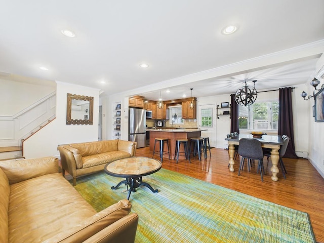 260 9th St, Bethpage, NY 11714 - living area with wood finished floors, stairway, crown molding, recessed lighting, and a chandelier