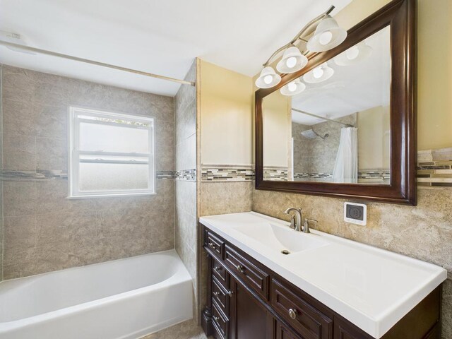 260 9th St, Bethpage, NY 11714 - bathroom with tile walls, vanity, and shower / tub combo with curtain