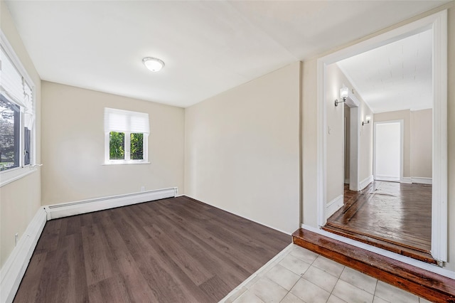 10 Leach St, Lynbrook, NY 11563 - unfurnished room featuring baseboard heating and wood finished floors