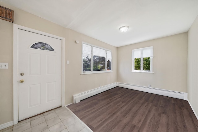 10 Leach St, Lynbrook, NY 11563 - entryway featuring wood finished floors and a baseboard heating unit