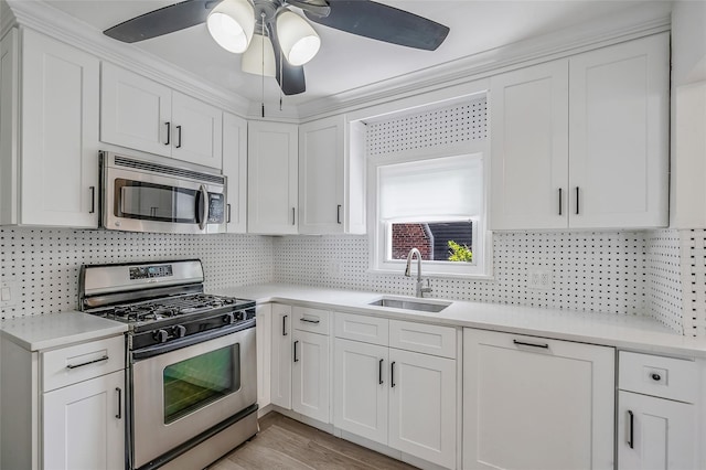 10 Leach St, Lynbrook, NY 11563 - kitchen with stainless steel appliances, light countertops, white cabinets, and a ceiling fan