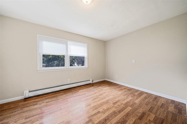 10 Leach St, Lynbrook, NY 11563 - spare room featuring a baseboard radiator and wood finished floors