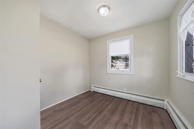 10 Leach St, Lynbrook, NY 11563 - spare room featuring wood finished floors and baseboard heating