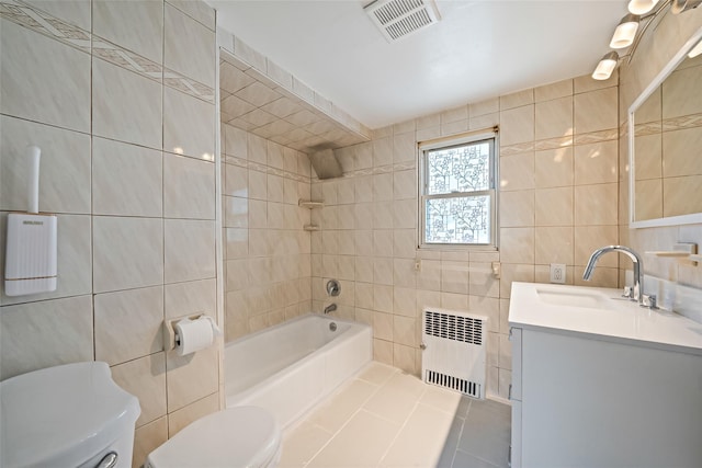 10 Leach St, Lynbrook, NY 11563 - full bathroom featuring radiator, tile walls, vanity, shower / tub combination, and tile patterned flooring