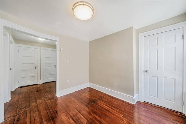10 Leach St, Lynbrook, NY 11563 - unfurnished room with dark wood finished floors and baseboards