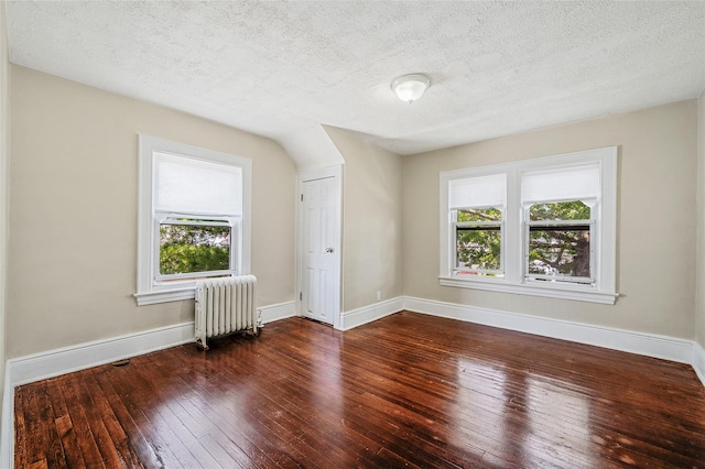 10 Leach St, Lynbrook, NY 11563 - bonus room with radiator heating unit, plenty of natural light, hardwood / wood-style flooring, and a textured ceiling