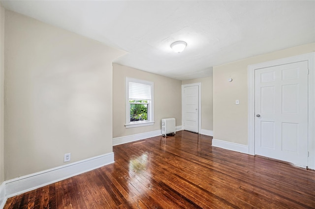 10 Leach St, Lynbrook, NY 11563 - spare room featuring radiator and hardwood / wood-style floors