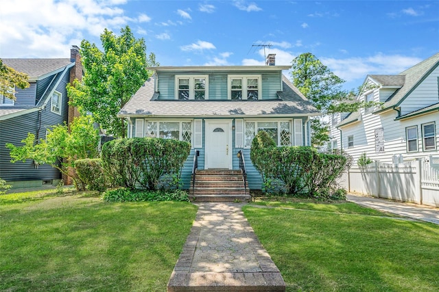 10 Leach St, Lynbrook, NY 11563 - bungalow featuring entry steps, a chimney, and roof with shingles