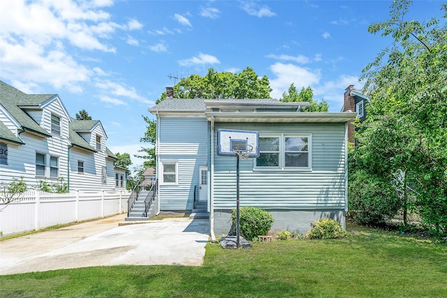 10 Leach St, Lynbrook, NY 11563 - back of property with a chimney and a patio area