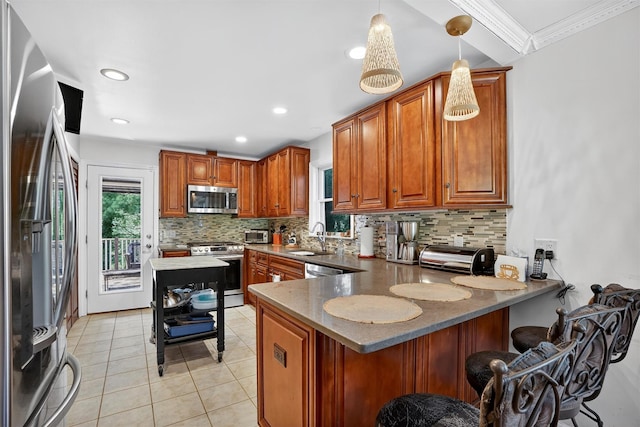 34 Winter Hill Rd, Tuckahoe, NY 10707 - kitchen with stainless steel appliances, a peninsula, tasteful backsplash, brown cabinetry, and a kitchen breakfast bar