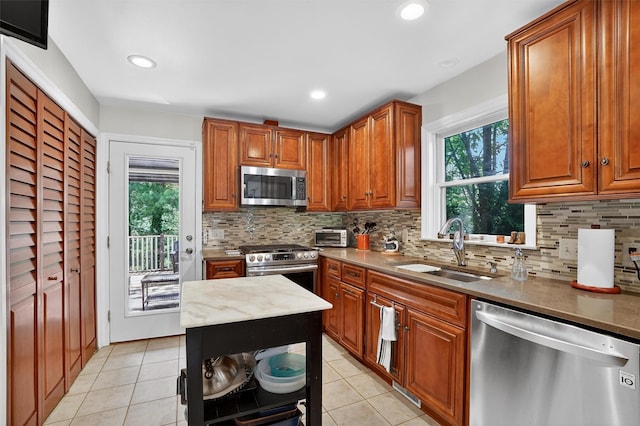 34 Winter Hill Rd, Tuckahoe, NY 10707 - kitchen with appliances with stainless steel finishes, light tile patterned floors, tasteful backsplash, brown cabinetry, and recessed lighting