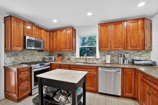 34 Winter Hill Rd, Tuckahoe, NY 10707 - kitchen with appliances with stainless steel finishes, light tile patterned flooring, brown cabinets, decorative backsplash, and recessed lighting