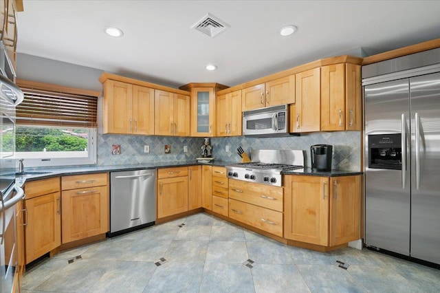 8 Kilmer Ave, Dix Hills, NY 11746 - kitchen featuring stainless steel appliances, decorative backsplash, glass insert cabinets, recessed lighting, and dark stone countertops