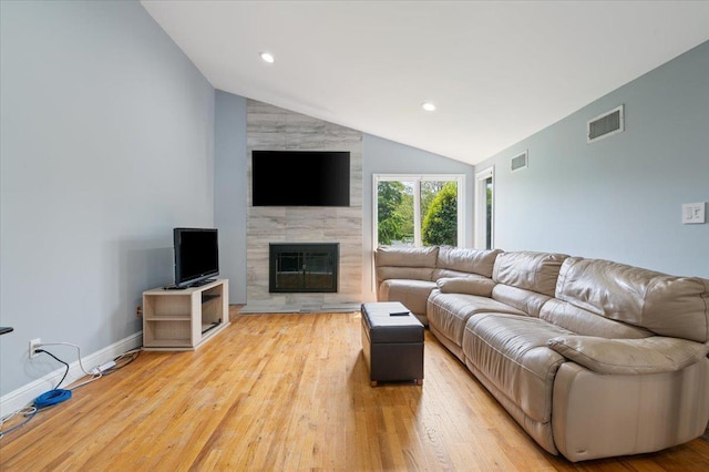 8 Kilmer Ave, Dix Hills, NY 11746 - living area featuring lofted ceiling, a tiled fireplace, light wood-style flooring, and recessed lighting