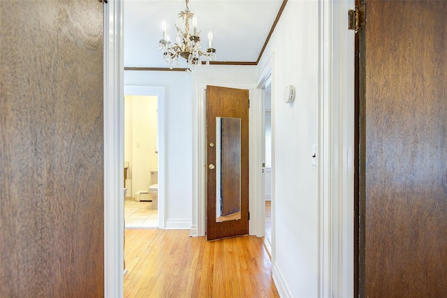 163-49 15th Dr, Whitestone, NY 11357 - hallway with light wood finished floors, a chandelier, and crown molding