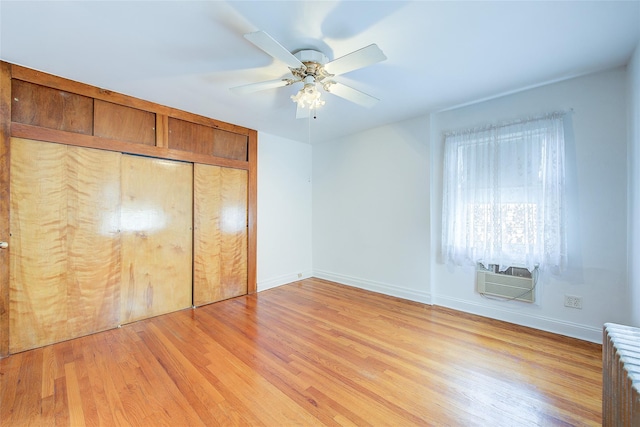 163-49 15th Dr, Whitestone, NY 11357 - unfurnished bedroom featuring radiator heating unit, light wood-style flooring, a closet, an AC wall unit, and ceiling fan