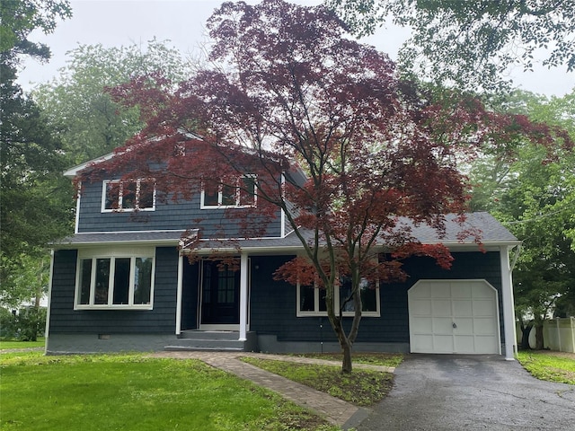 95 Muncie Rd, West Babylon, NY 11704 - view of front of home featuring a front lawn, asphalt driveway, and an attached garage