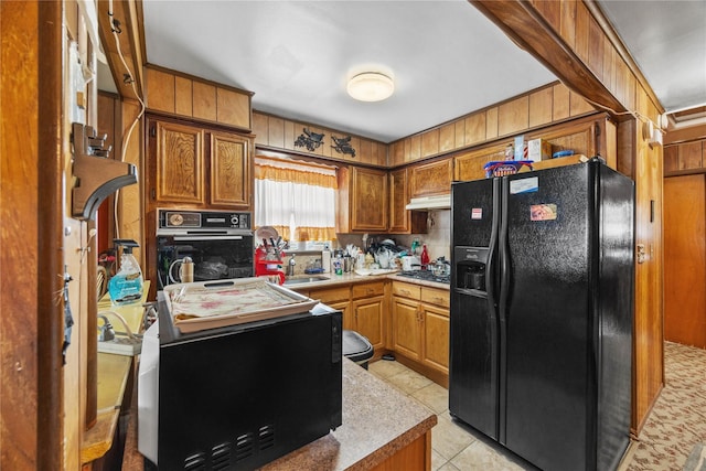 1112 Saint Lawrence Ave Front, Front, Bronx, NY 10472 - kitchen featuring black appliances, light tile patterned flooring, light countertops, and brown cabinets