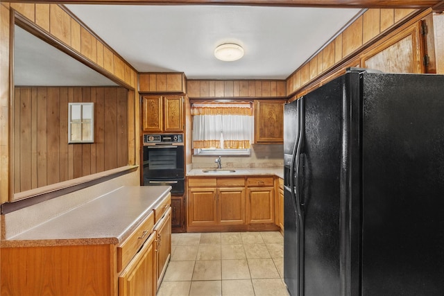 1112 Saint Lawrence Ave Front, Front, Bronx, NY 10472 - kitchen featuring black appliances, a warming drawer, light countertops, wood walls, and brown cabinets