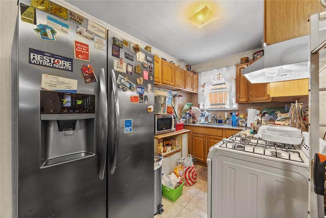 1112 Saint Lawrence Ave Front, Front, Bronx, NY 10472 - kitchen with appliances with stainless steel finishes, light tile patterned flooring, brown cabinets, and light countertops