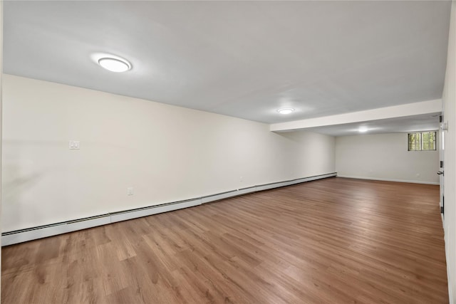 1112 Saint Lawrence Ave Front, Front, Bronx, NY 10472 - below grade area with wood finished floors and a baseboard heating unit