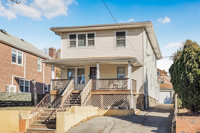 22 King Ave, Yonkers, NY 10704 - view of front of home featuring a porch, asphalt driveway, stairway, and a garage