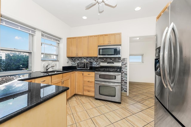 22 King Ave, Yonkers, NY 10704 - kitchen featuring stainless steel appliances, light brown cabinets, tasteful backsplash, ceiling fan, and healthy amount of natural light