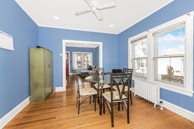 22 King Ave, Yonkers, NY 10704 - dining room with radiator, ceiling fan, light wood-style floors, and crown molding