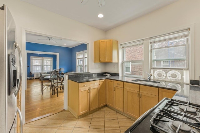 22 King Ave, Yonkers, NY 10704 - kitchen with stainless steel fridge, ceiling fan, cooktop, a peninsula, and light tile patterned floors