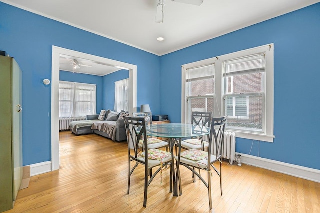22 King Ave, Yonkers, NY 10704 - dining room with ceiling fan, radiator heating unit, and light wood-style floors