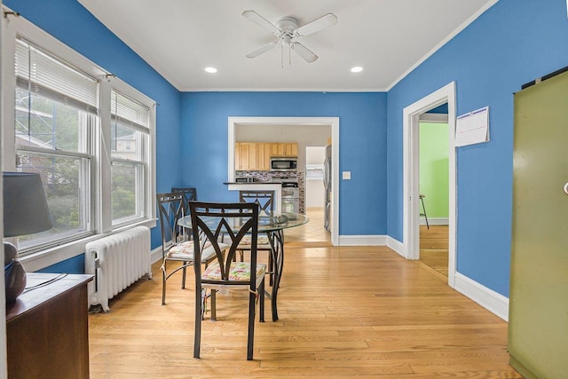 22 King Ave, Yonkers, NY 10704 - dining area with radiator heating unit, a ceiling fan, light wood-style floors, crown molding, and recessed lighting