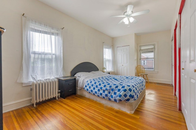 22 King Ave, Yonkers, NY 10704 - bedroom with radiator, light wood-type flooring, and multiple windows