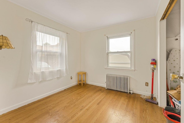 22 King Ave, Yonkers, NY 10704 - empty room featuring radiator heating unit, light wood-type flooring, healthy amount of natural light, and ornamental molding