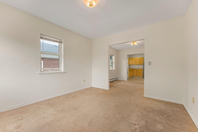 22 King Ave, Yonkers, NY 10704 - unfurnished room featuring light carpet and a baseboard heating unit