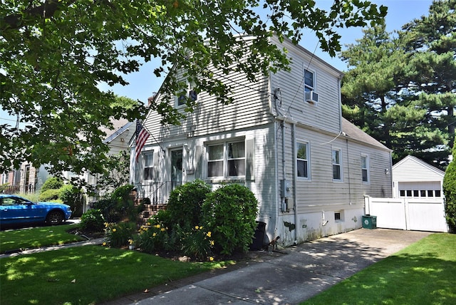 22 Hollywood Ave, Lynbrook, NY 11563 - view of side of property with a yard, an outbuilding, and a detached garage
