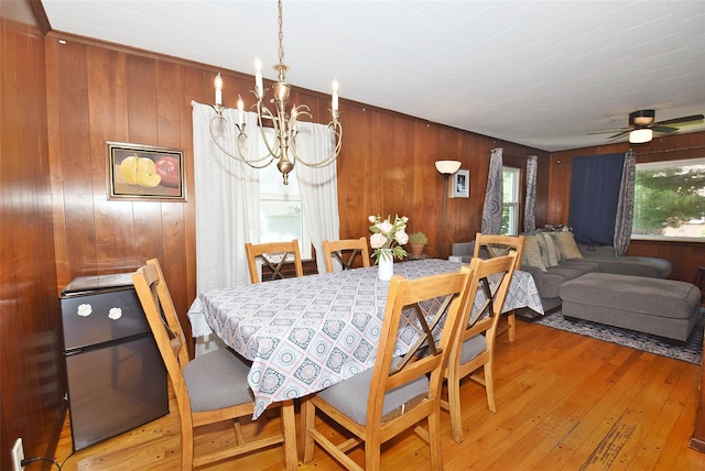 22 Hollywood Ave, Lynbrook, NY 11563 - dining room with plenty of natural light, a chandelier, wooden walls, light wood-style floors, and ceiling fan