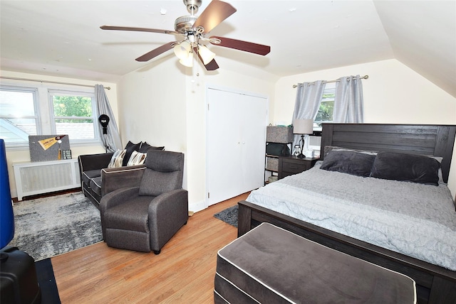 22 Hollywood Ave, Lynbrook, NY 11563 - bedroom with radiator, light wood-style floors, vaulted ceiling, and ceiling fan
