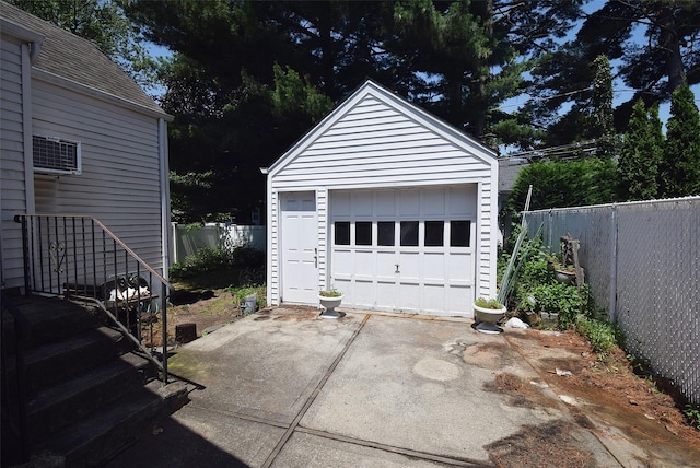 22 Hollywood Ave, Lynbrook, NY 11563 - detached garage featuring driveway and a wall mounted AC