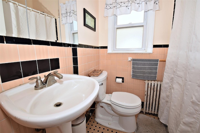 22 Hollywood Ave, Lynbrook, NY 11563 - bathroom with radiator, tile walls, a wainscoted wall, and a shower with curtain
