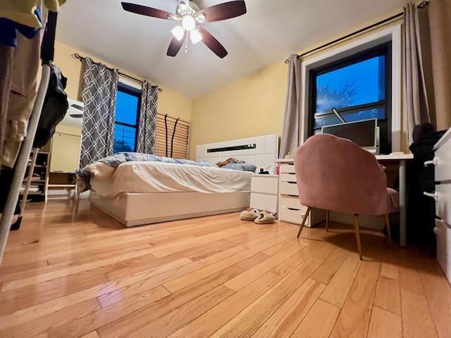 75-15 210th St Unit 2E, Bayside, NY 11364 - bedroom with hardwood / wood-style floors, vaulted ceiling, and ceiling fan