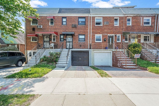 11708A 233rd St, Cambria Heights, NY 11411 - view of property with driveway, a garage, and brick siding