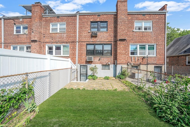11708A 233rd St, Cambria Heights, NY 11411 - back of property with brick siding, a chimney, and a fenced backyard