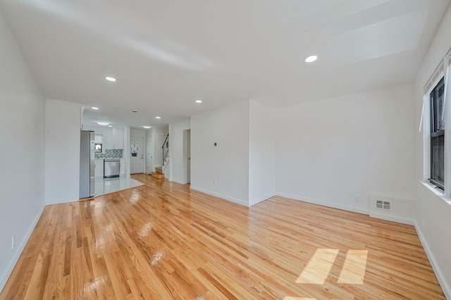 11708A 233rd St, Cambria Heights, NY 11411 - unfurnished living room featuring light wood-style floors, recessed lighting, and a fireplace