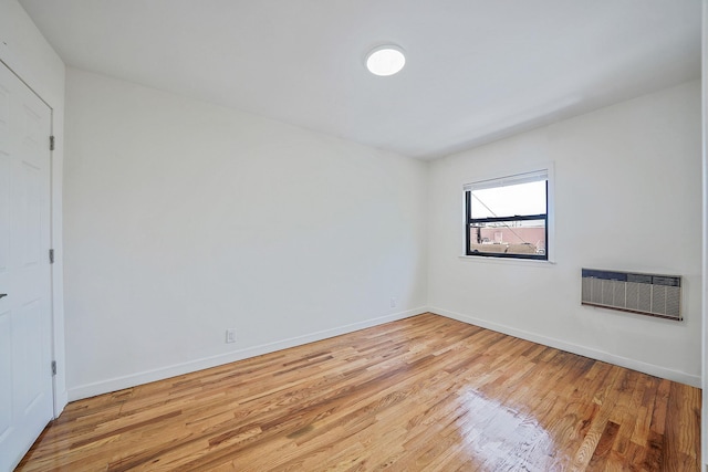 11708A 233rd St, Cambria Heights, NY 11411 - unfurnished bedroom featuring light wood-style flooring and a wall mounted air conditioner