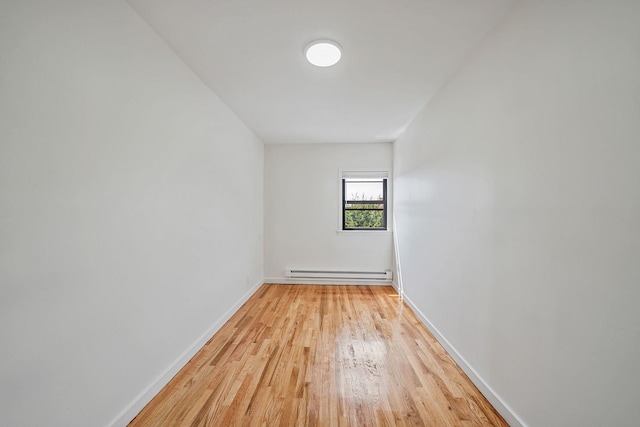 11708A 233rd St, Cambria Heights, NY 11411 - empty room featuring baseboard heating and light wood-style floors